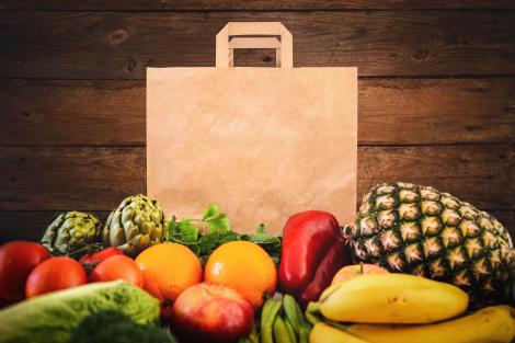 Bolsas de papel reciclado con base ancha con frutas y verduras alrededor